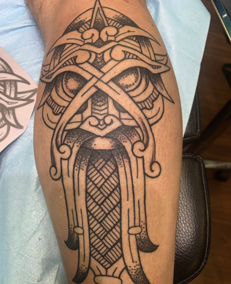 Sword and helmet tattoo by Pat Saginaw MI